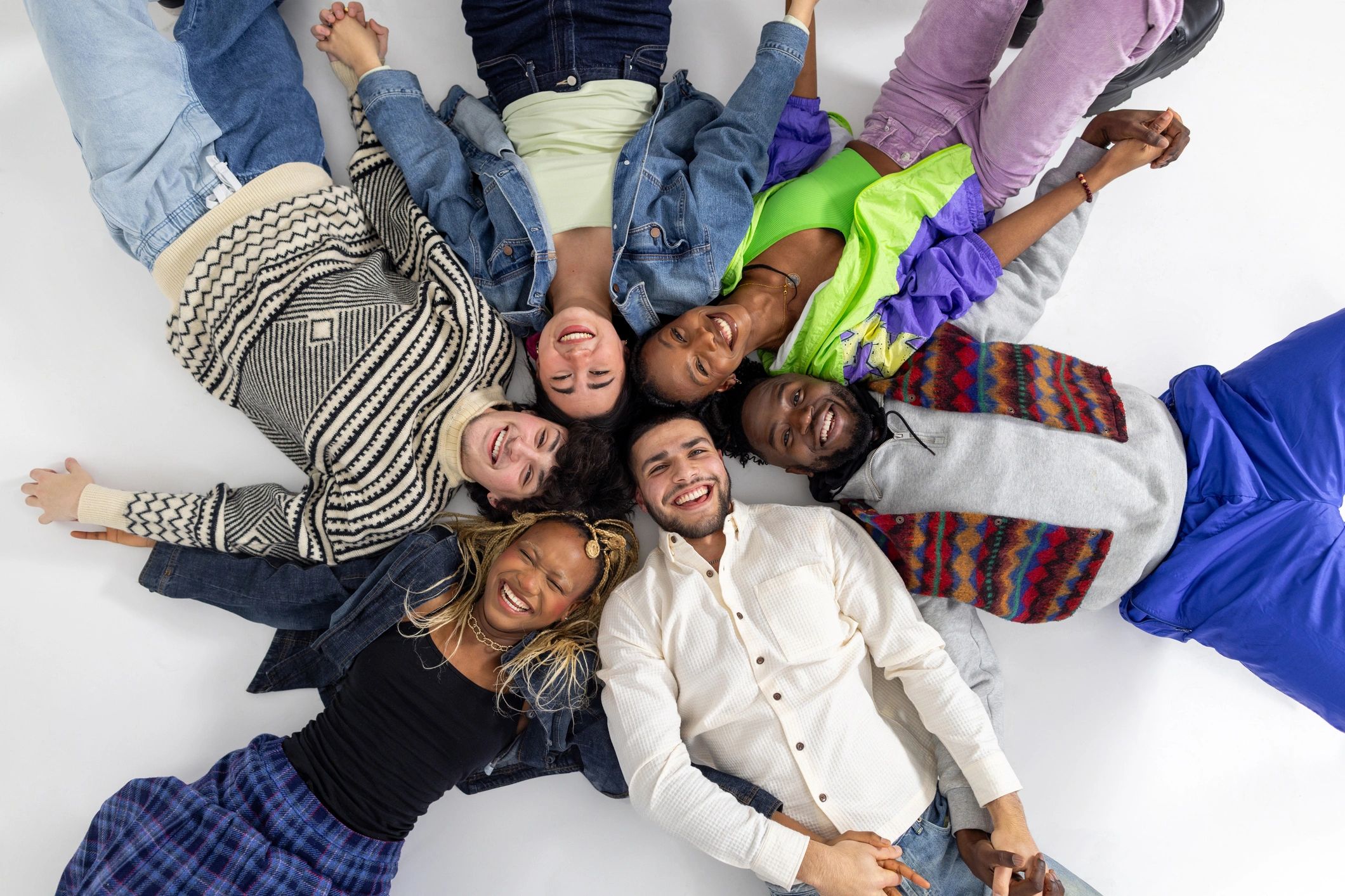Group of young adults smiling together in a studio setting